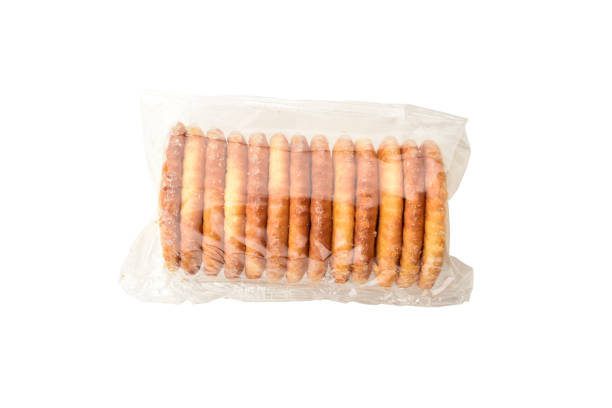 istock Cracker biscuit in transparent wrapper isolated on white background with clipping path, salty snack 1299324583