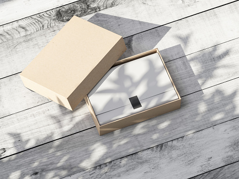 Open cardboard Gift Box Mockup with white wrapping paper on wooden table outdoors. 3d rendering