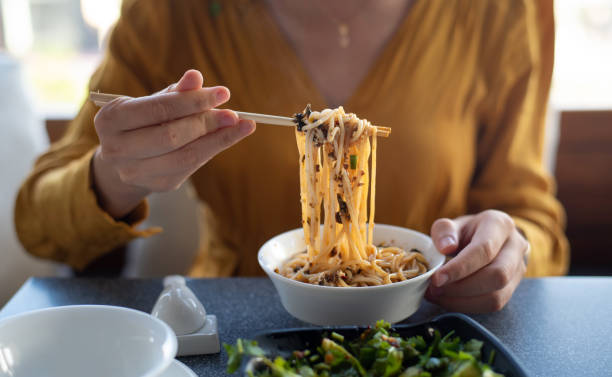 istock Person having noodles in the restaurant closeup 1299326695