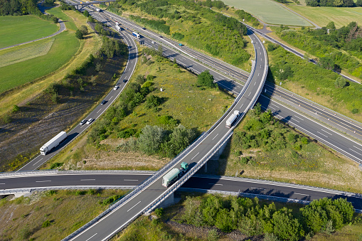 A large highway intersection with car and truck traffic viewed from above.