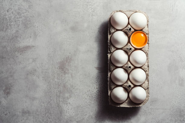 istock Box of eggs on gray background 1299327836