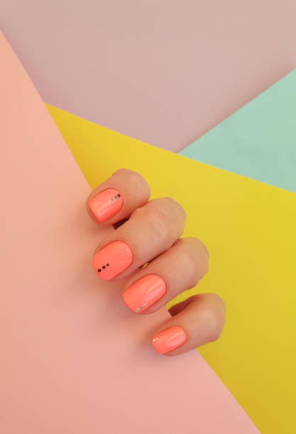 istock female hand beautiful manicure on a colored background 1299327923