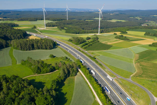 istock Trucks on Highway and Wind Turbines, Aerial View 1299327997