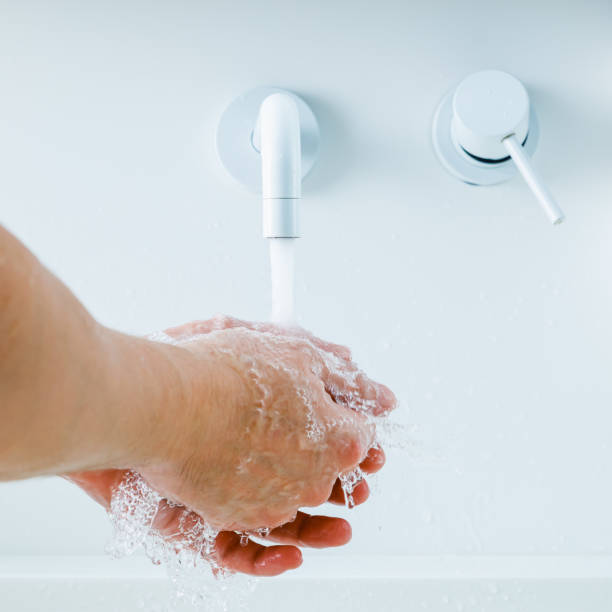 istock hands washing under the faucet with flowing water 1299330121