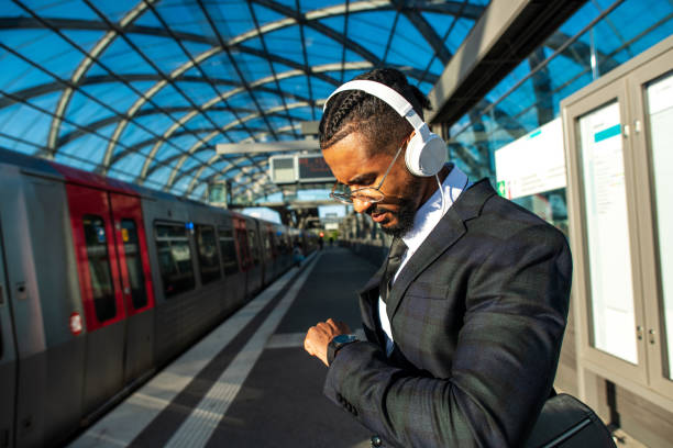 istock Handsome man in a suit at the train station 1299331520