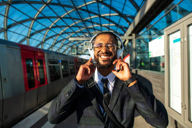 istock Handsome man in a suit at the train station 1299331593
