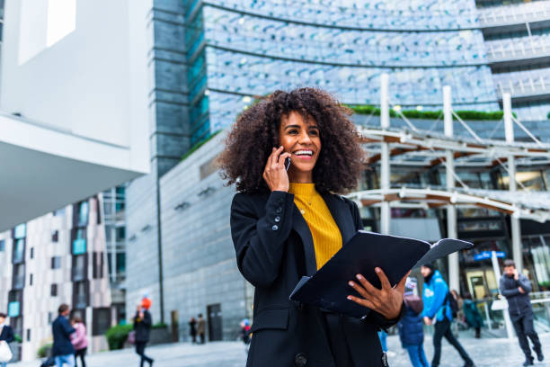 istock Businesswoman uses phone in public 1299332585