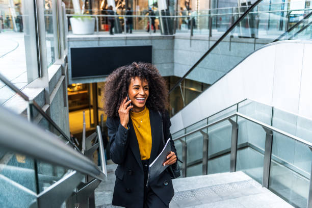 istock Businesswoman uses phone in public 1299333012