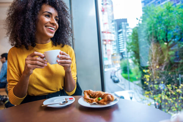 istock An elegant woman in a Coffee shop 1299333017