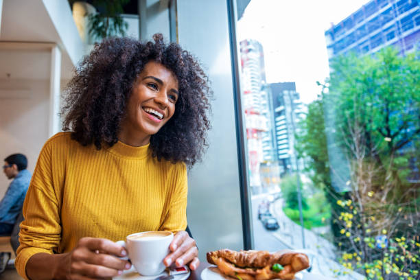 istock An elegant woman in a Coffee shop 1299333028