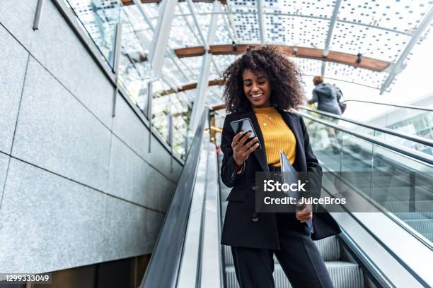 Businesswoman Uses Phone In Public Stock Photo - Download Image Now - Banking, Portable Information Device, Customer