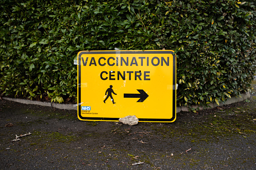 Vaccination Centre direction sign in car park.