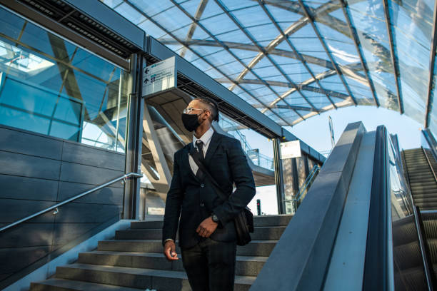 istock Businessman with a protective face mask in the city 1299334978