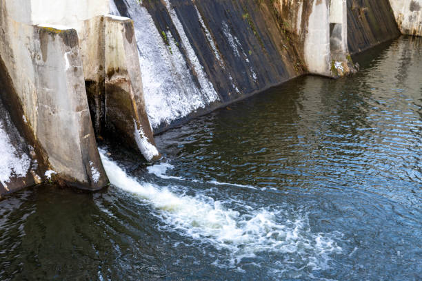 istock Water drain in a small dam. View of the overflow channel in the hydrotechnical structure. Winter season. 1299335286