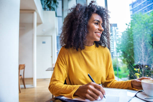 istock Beautiful woman doing paperwork in a nearby Cafe 1299335829