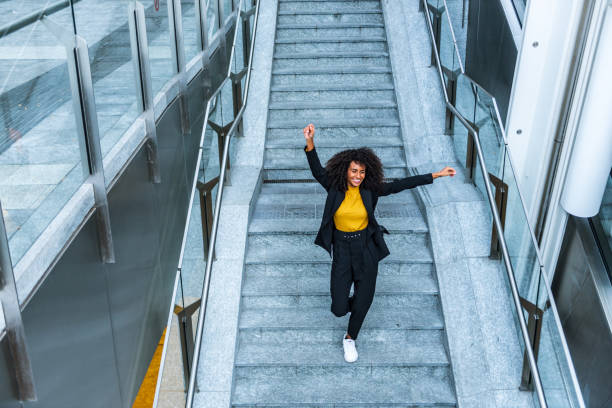 istock Beautiful businesswoman on a staircase 1299336573