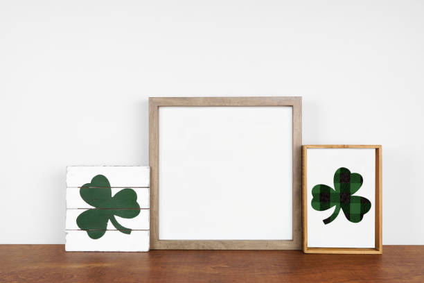 istock Mock up wood frame with St Patricks Day rustic decor on a wood shelf against a white wall 1299338893