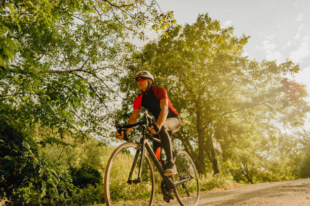 istock Senior triathlete cycling in nature 1299341550