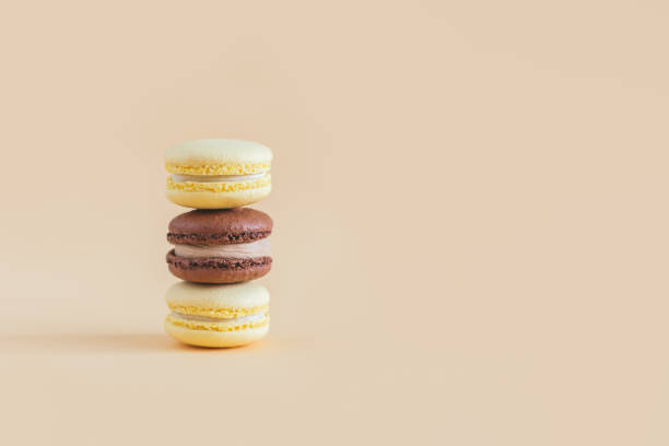 istock Tasty french macarons on a yellow pastel background. 1299341603