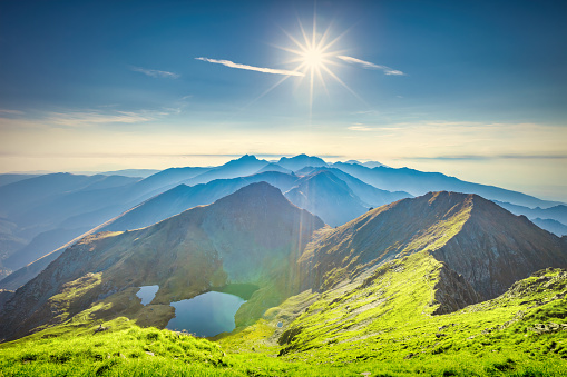 Landscape stock photograph of Lake Capra and the Fagaras Mountains, the highest mountains in the Southern Carpathians in Romania.