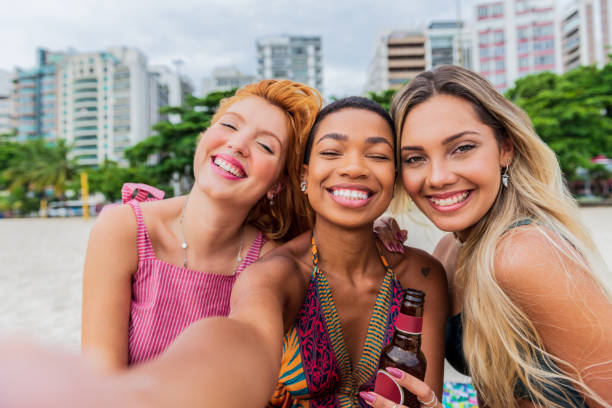 istock Friends drinking beer on the beach and chat 1299343926