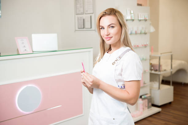 istock Professional eyelash extension master at beauty salon 1299343974