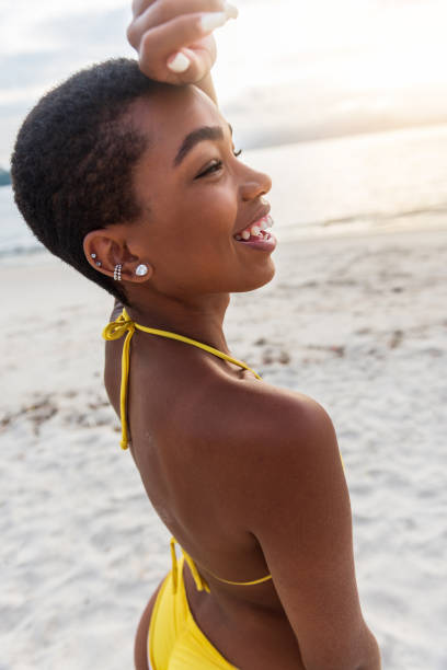 istock Attractive woman in bikini at the beach 1299345059