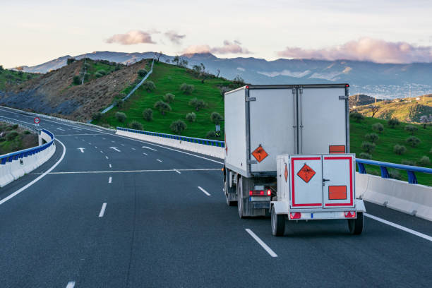 Truck with dangerous goods (ADR) transporting explosives. Truck with a small trailer, with panels of dangerous goods for transport of explosives, circulating on the highway. explosive stock pictures, royalty-free photos & images