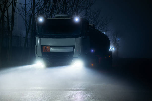 istock Truck seen from the front at night and with fog. 1299345827