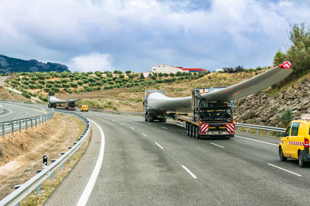 Special and bulky transport, wind turbine blades. Several special transport trucks on the road transporting wind turbine blades. blade stock pictures, royalty-free photos & images
