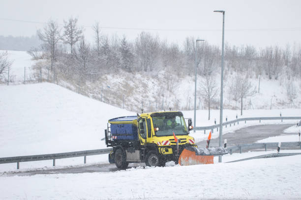 istock snow plow, winter service on a wet road 1299345879