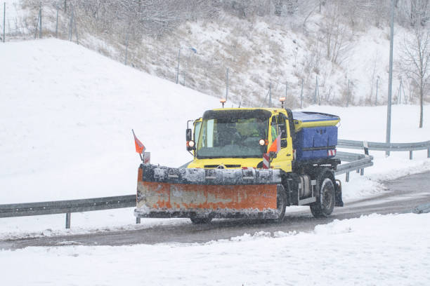 istock snow plow, winter service on a wet road 1299345940