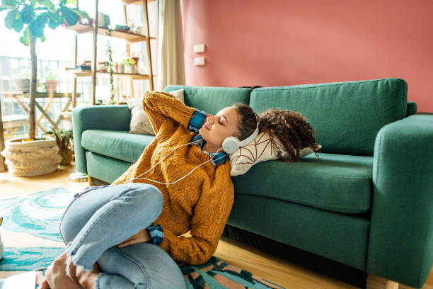 istock Relaxing in cozy living room with good music 1299348764