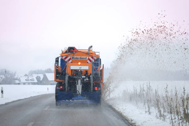 istock snow plow, winter service on a wet road 1299348809