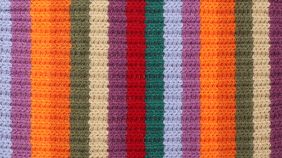 background of handmade multicolor crochet squares with different crochet borders