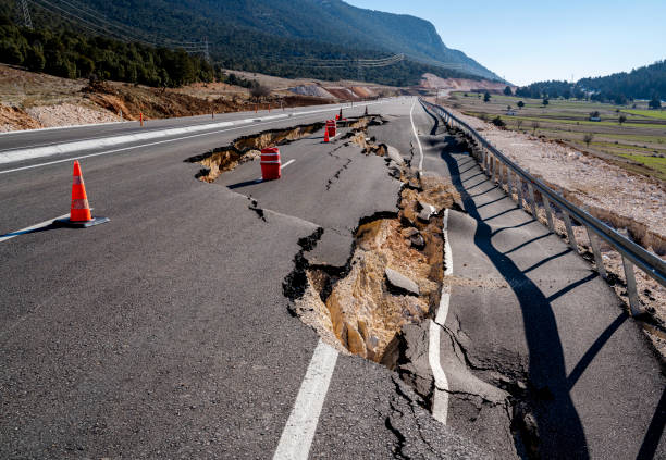 carretera de asfalto colapsada y grietas en la carretera - quake fotografías e imágenes de stock