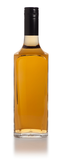 This is a front view photograph of a blank gold liquor bottle isolated on a white background
