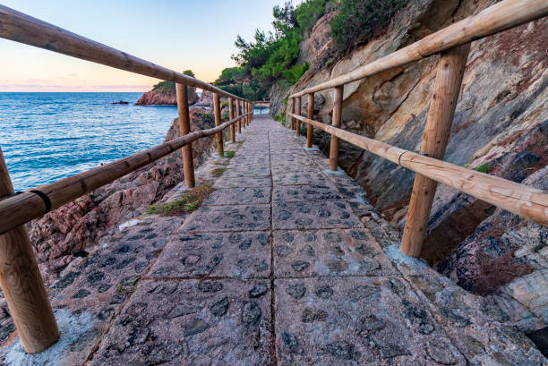istock I walk along the coast with wooden railings at sunset 1299354846