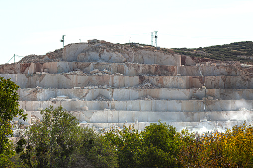 View of a marble quarry all over a hill.