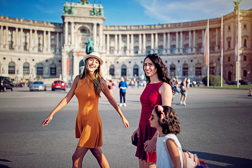 Happy girlfriends are walking and having fun in center of Vienna