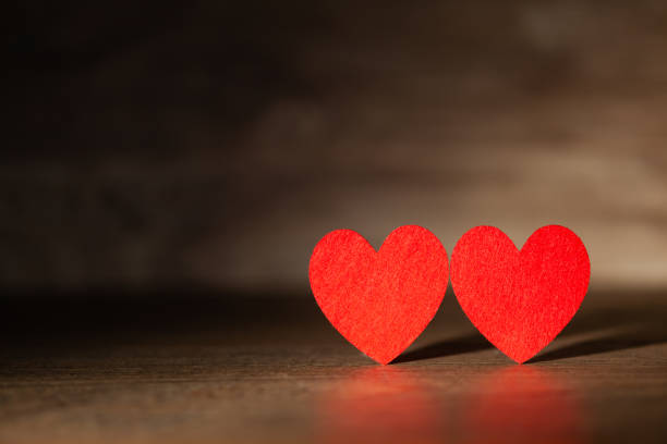 istock postcard two red hearts on a wooden background 1299357651