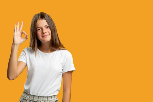 istock satisfied child advertising background girl ok 1299359672