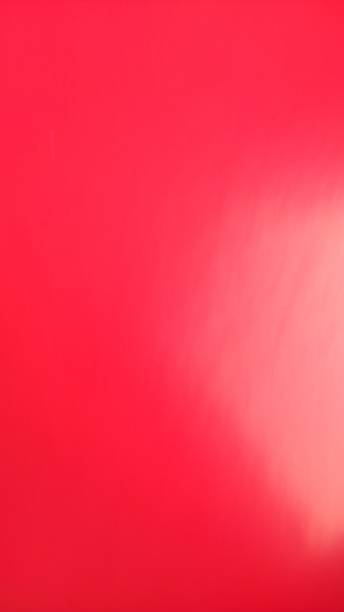 istock red or scarlet background with light gradient. Bright color. Colored paper close up. Copy space 1299359688