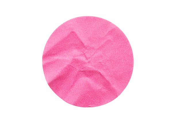 istock Blank pink round adhesive paper sticker label isolated on white background 1299359727