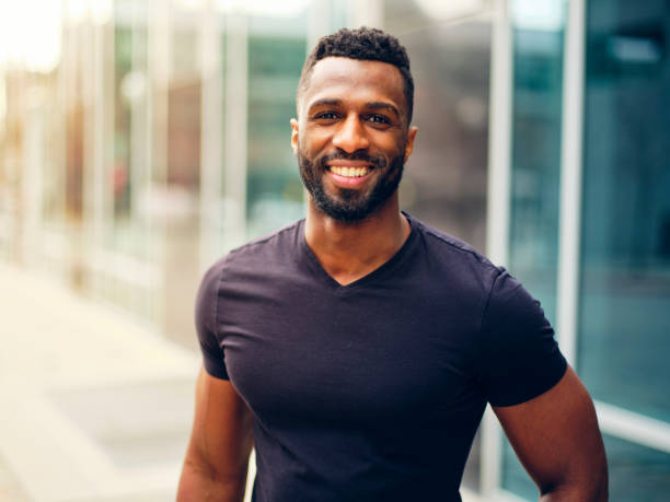 istock Fit Man Standing Outdoors in a City 1299360135