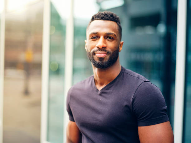 istock Fit Man Standing Outdoors in a City 1299360143
