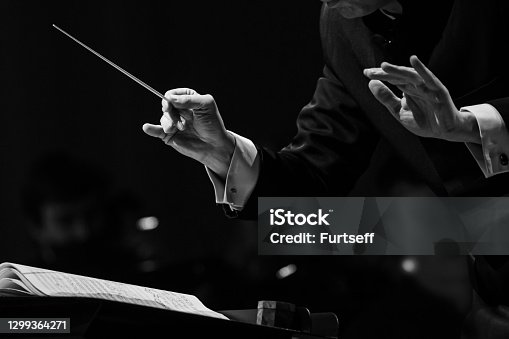 istock Hands of a conductor of a symphony orchestra close-up 1299364271