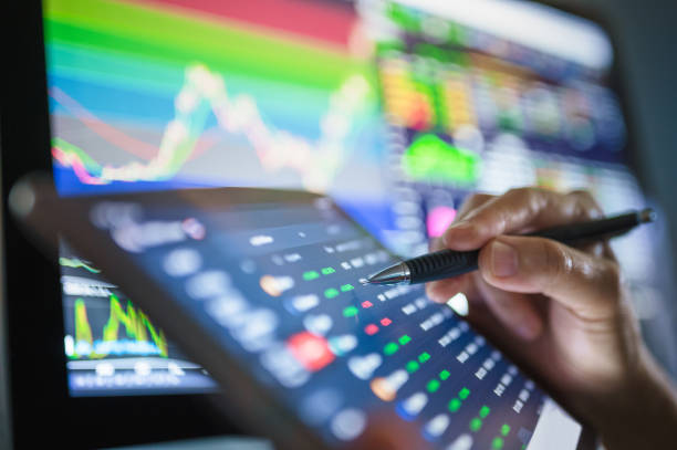 istock Businessperson using mobile online trading with ticker and bid - offer by fundamental analysis 1299372378