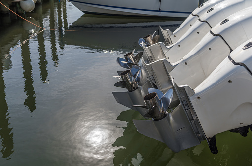 Metal control levers on panel of contemporary catamaran moored in sea bay on sunny day