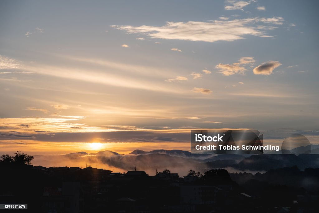 Morning view over Nabari City Foggy autumn morning cityscape view over Nabari City during dawn in Mie Prefecture, Japan. Cloud - Sky Stock Photo